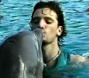 JC kissing a dolphin